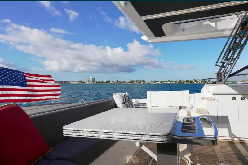 Slide: The Image of Azimut S6 Sports Fly 2021 yacht deck with ocean view and American flag. - 8