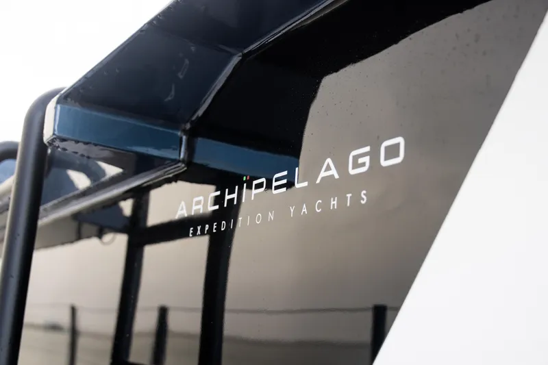Slide: The Image of 2025 Archipelago 47 Expedition Yacht branding on black hull. - 19
