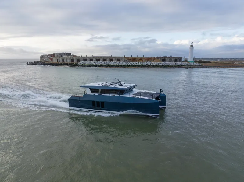 Slide: The Image of 2025 Archipelago 47 boat cruising near a lighthouse and coastal ruins. - 4