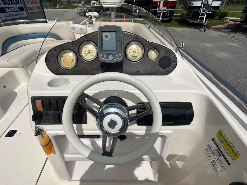 Slide: The Image of 2007 Hurricane 201 FUNDECK c boat dashboard with steering wheel and gauges. - 8