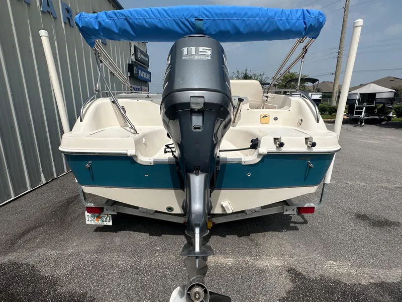 Slide: The Image of 2007 Hurricane 201 FUNDECK c boat with 115 horsepower outboard motor, blue canopy, and trailer. - 3