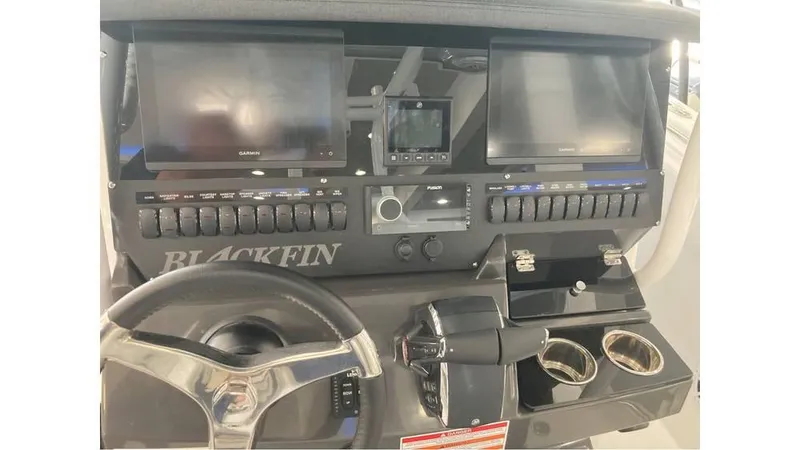 Slide: The Image of 2024 Blackfin 272 CC boat dashboard with dual screens and control panel. - 10