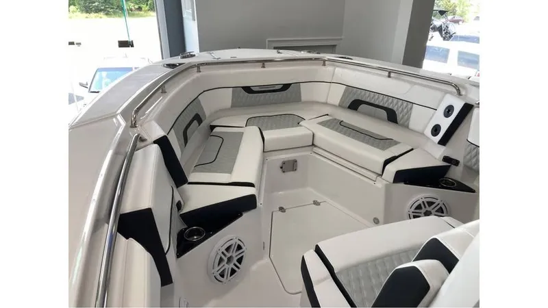Slide: The Image of 2024 Blackfin 272 CC boat interior with cushioned seating and built-in speakers. - 14