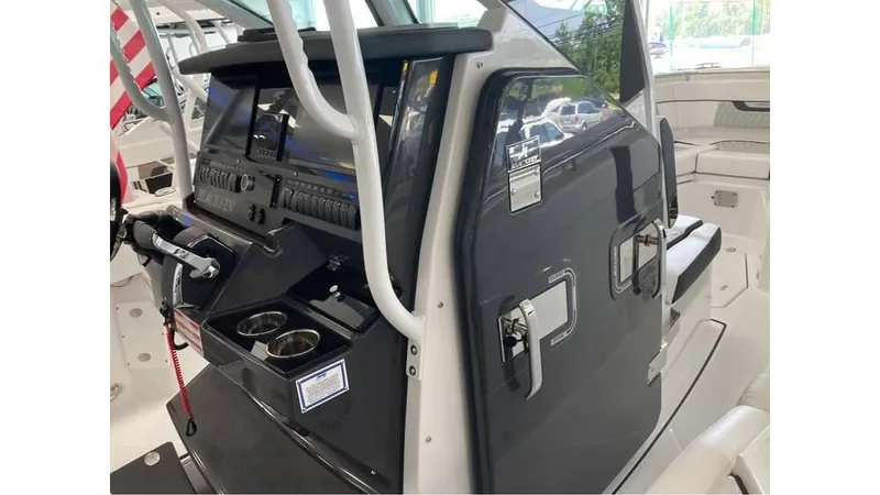 Slide: The Image of 2024 Blackfin 272 CC center console with modern navigation equipment and cup holders. - 18