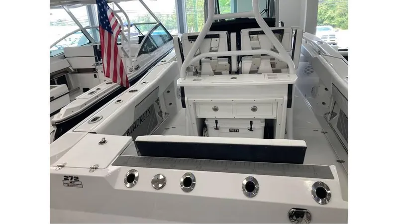 Slide: The Image of 2024 Blackfin 272 CC center console boat interior with seating and fishing rod holders. - 21