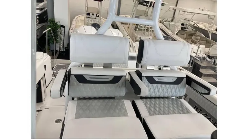 Slide: The Image of 2024 Blackfin 272 CC boat interior seating in showroom. - 9