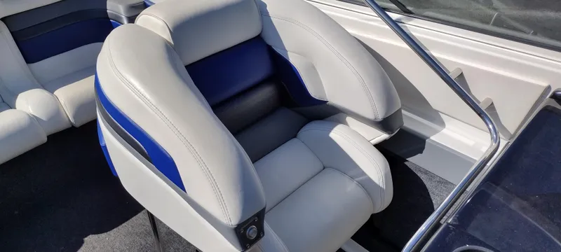Slide: The Image of 1991 Formula 272 SR1 boat interior with cushioned seating and blue accents. - 13