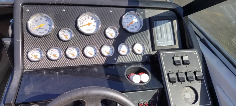 Slide: The Image of Dashboard of a 1991 Formula 272 SR1 boat with gauges and controls. - 16