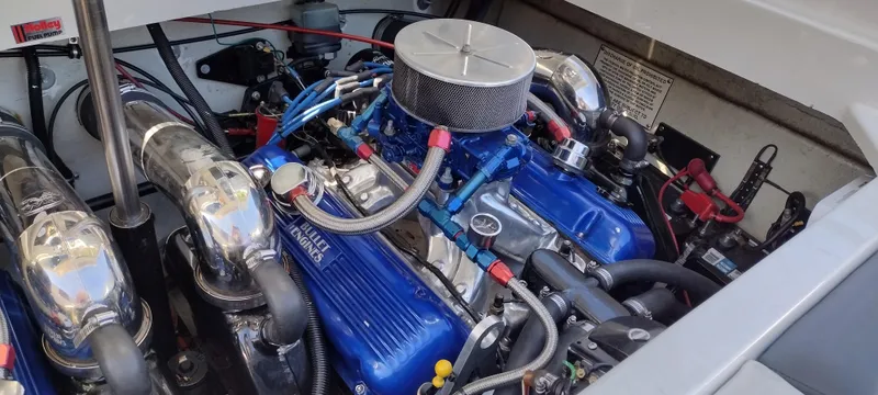 Slide: The Image of 1991 Formula 272 SR1 engine compartment with blue valve covers and chrome air filter. - 26