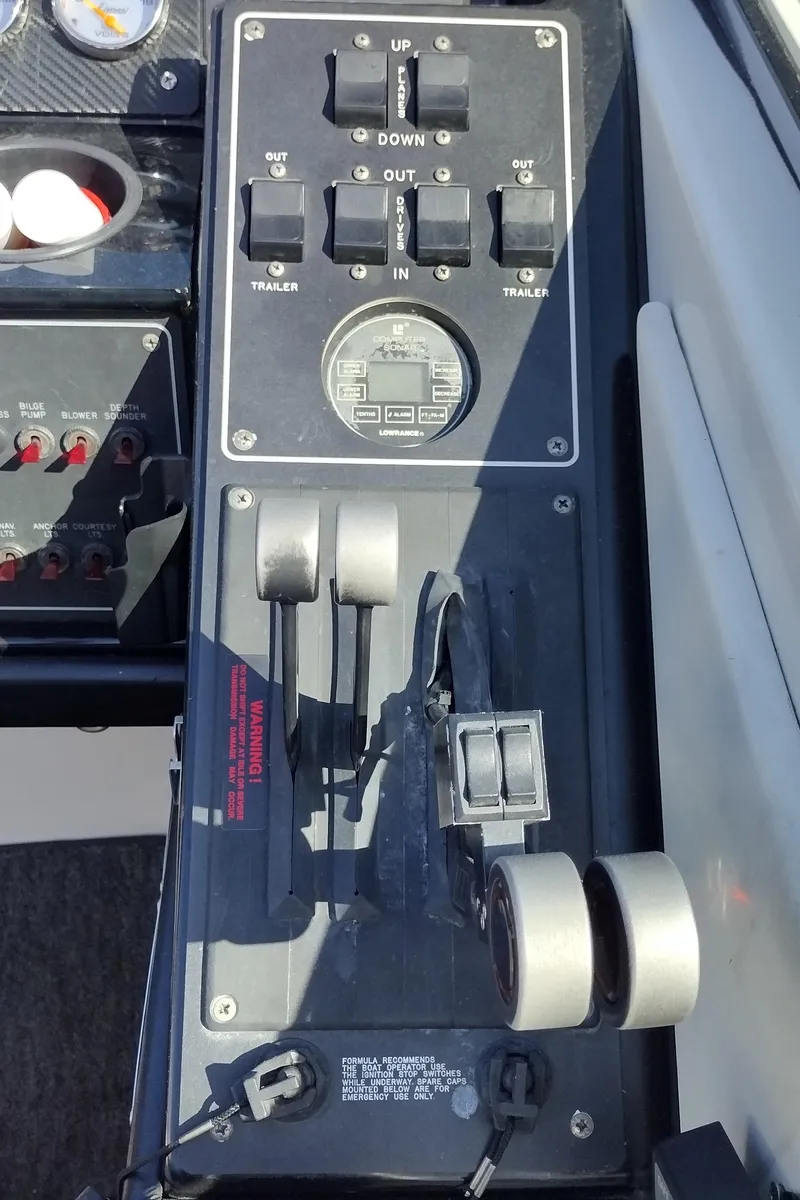 Slide: The Image of Control panel of a 1991 Formula 272 SR1 boat with throttle and trim switches. - 35