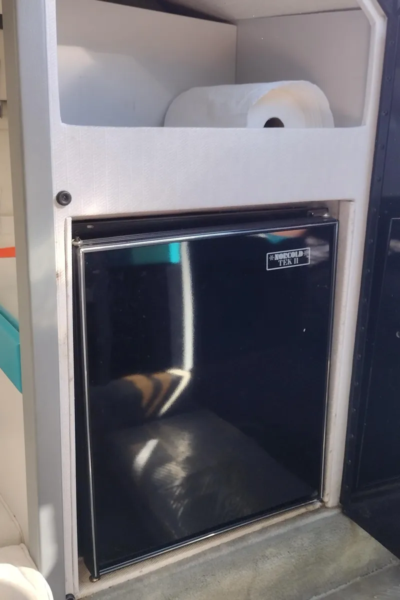 Slide: The Image of 1991 Formula 272 SR1 boat interior with mini fridge and paper towel holder. - 37