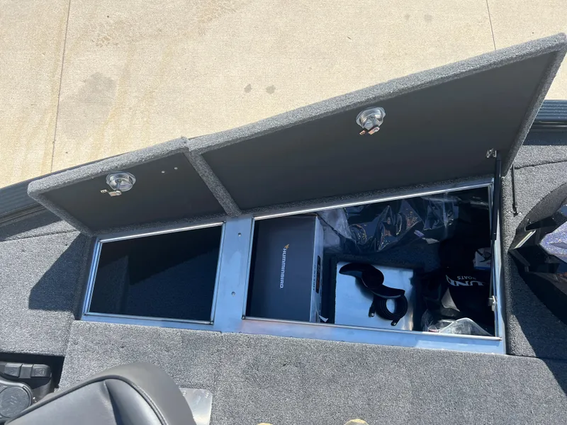 Slide: The Image of 2024 Lund 1875 Pro-V Bass XS storage compartments open, revealing interior space and accessories. - 10