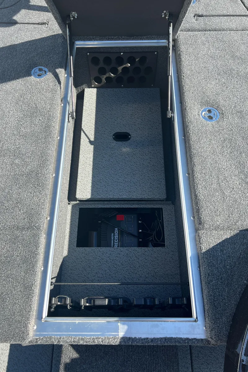 Slide: The Image of 2024 Lund 1875 Pro-V Bass XS storage compartment with battery and rod holders. - 11