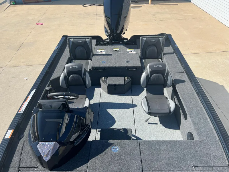 Slide: The Image of 2024 Lund 1875 Pro-V Bass XS fishing boat with four seats and a powerful outboard motor. - 12