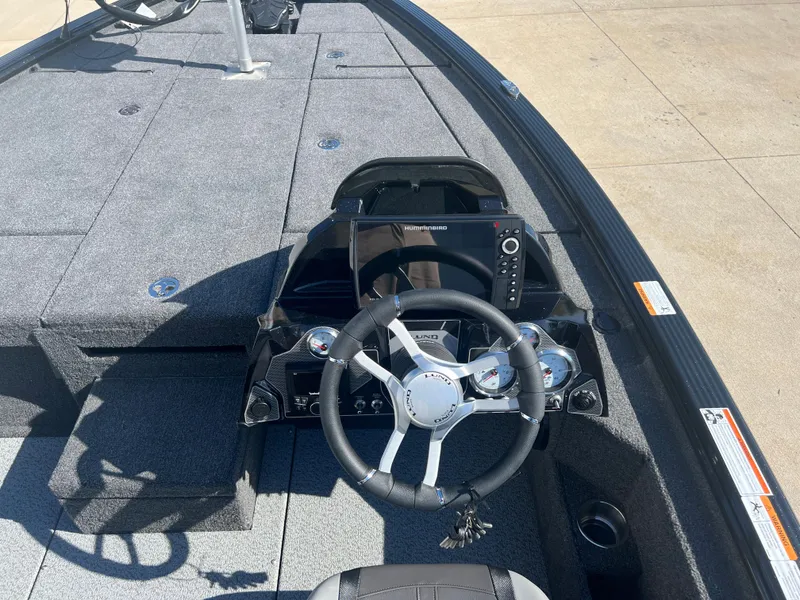 Slide: The Image of 2024 Lund 1875 Pro-V Bass XS boat interior with steering wheel and control panel. - 13