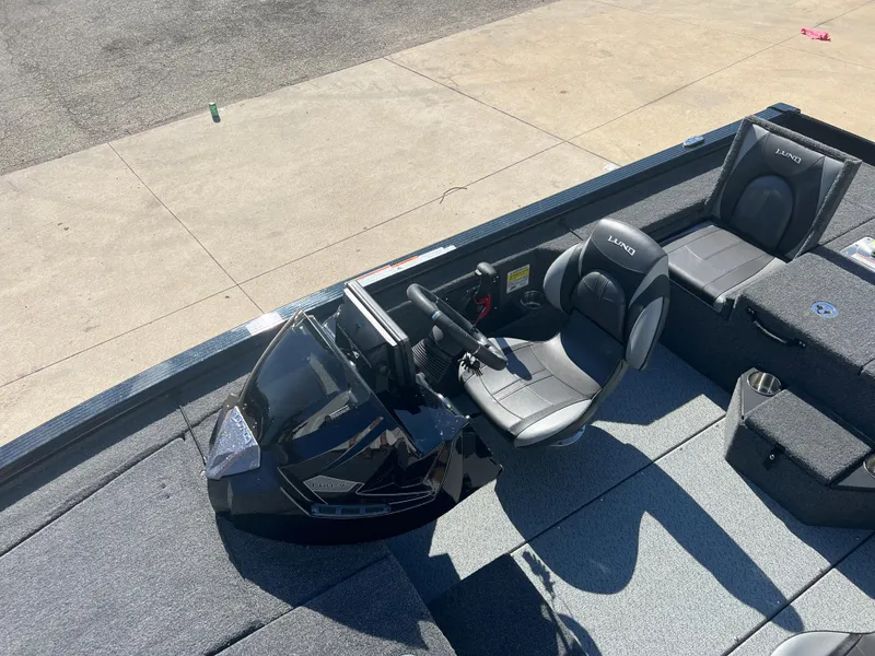 Slide: The Image of 2024 Lund 1875 Pro-V Bass XS boat interior with steering console and seating. - 14