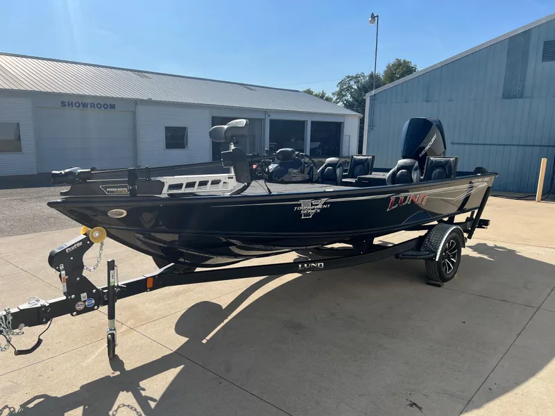 Slide: The Image of 2024 Lund 1875 Pro-V Bass XS boat on trailer outside showroom. - 2