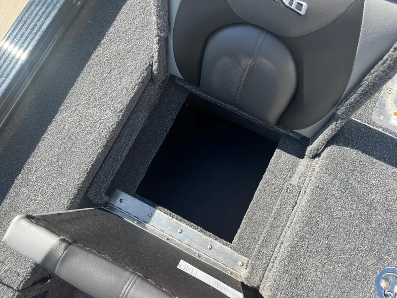 Slide: The Image of 2024 Lund 1875 Pro-V Bass XS storage compartment with open hatch. - 20