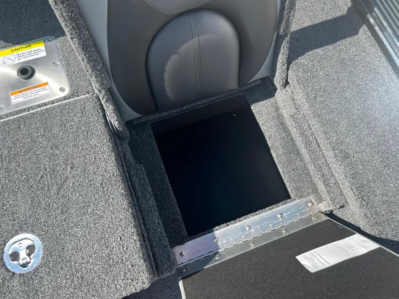 Slide: The Image of 2024 Lund 1875 Pro-V Bass XS storage compartment with open hatch. - 21