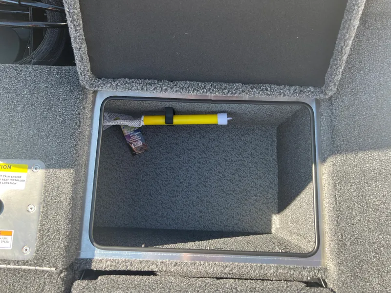 Slide: The Image of 2024 Lund 1875 Pro-V Bass XS storage compartment with safety equipment. - 23
