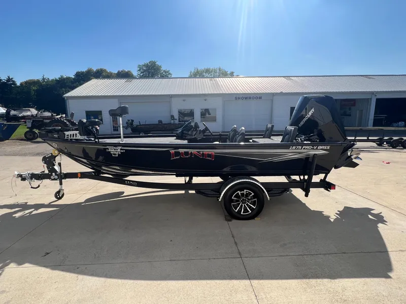 Slide: The Image of 2024 Lund 1875 Pro-V Bass XS boat on trailer outside showroom. - 3