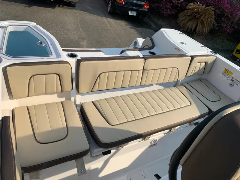 Slide: The Image of 2023 Yamaha Boats 255 FSH Sport E interior seating with beige upholstery. - 11