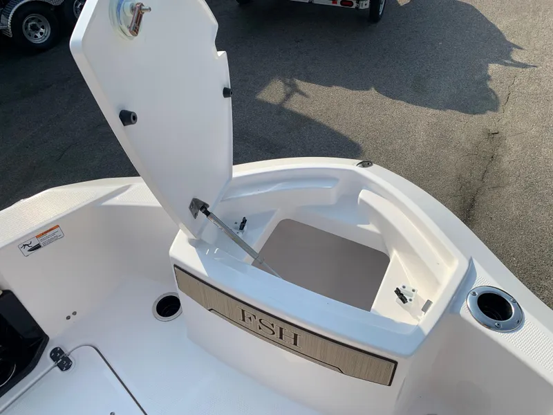 Slide: The Image of 2023 Yamaha Boats 255 FSH Sport E open storage compartment on deck. - 15