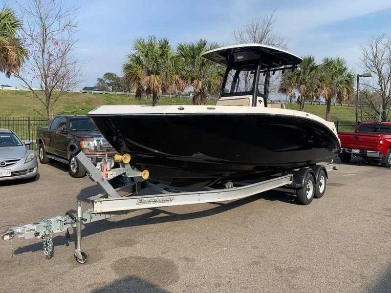 Slide: The Image of 2023 Yamaha Boats 255 FSH Sport E on trailer in parking lot. - 2