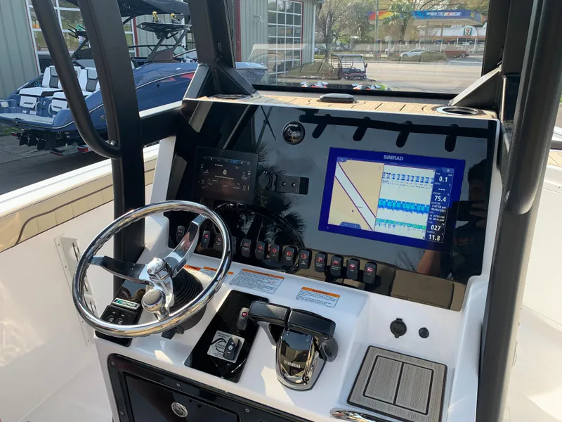 Slide: The Image of 2023 Yamaha Boats 255 FSH Sport E dashboard with steering wheel and navigation display. - 20