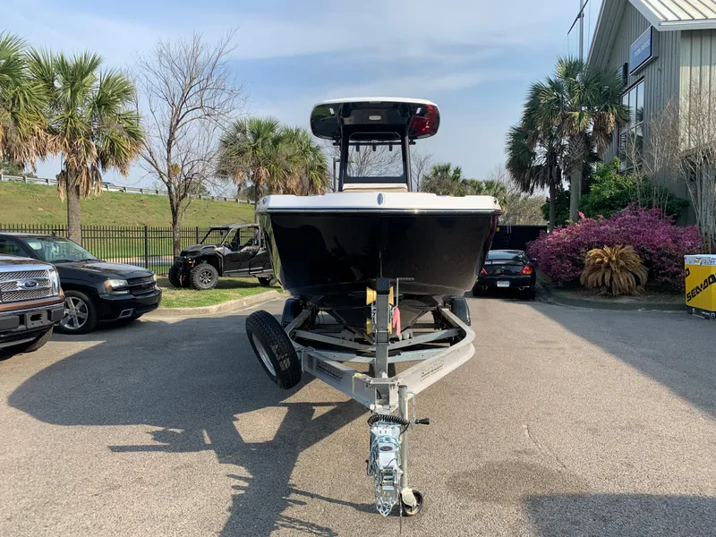 Slide: The Image of 2023 Yamaha Boats 255 FSH Sport E on trailer, parked outdoors with palm trees in background. - 3