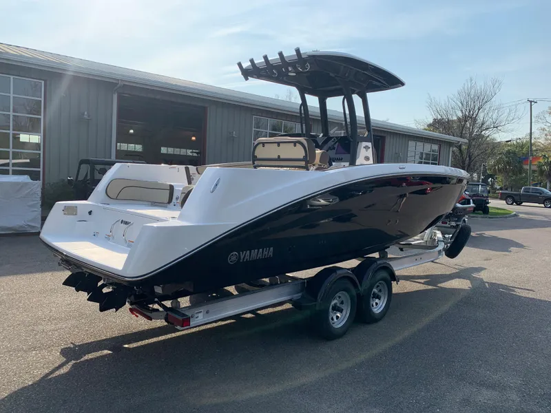 Slide: The Image of 2023 Yamaha Boats 255 FSH Sport E on a trailer outside a warehouse. - 6