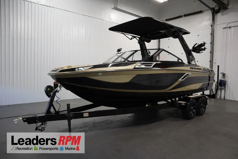 The Image of 2024 Centurion Ri230 boat on trailer in showroom, Leaders RPM logo visible. - 0