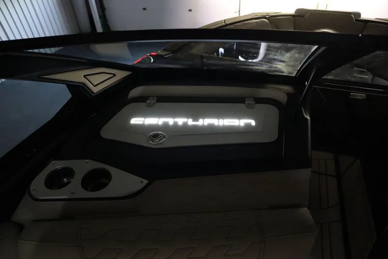 Slide: The Image of 2024 Centurion Ri230 boat interior with illuminated logo and sleek design. - 16