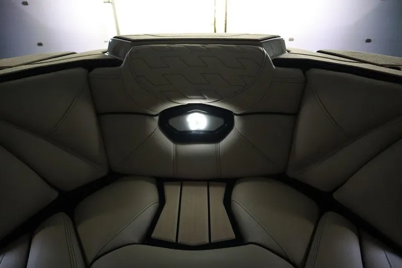 Slide: The Image of 2024 Centurion Ri230 boat interior with sleek, modern upholstery and ambient lighting. - 18