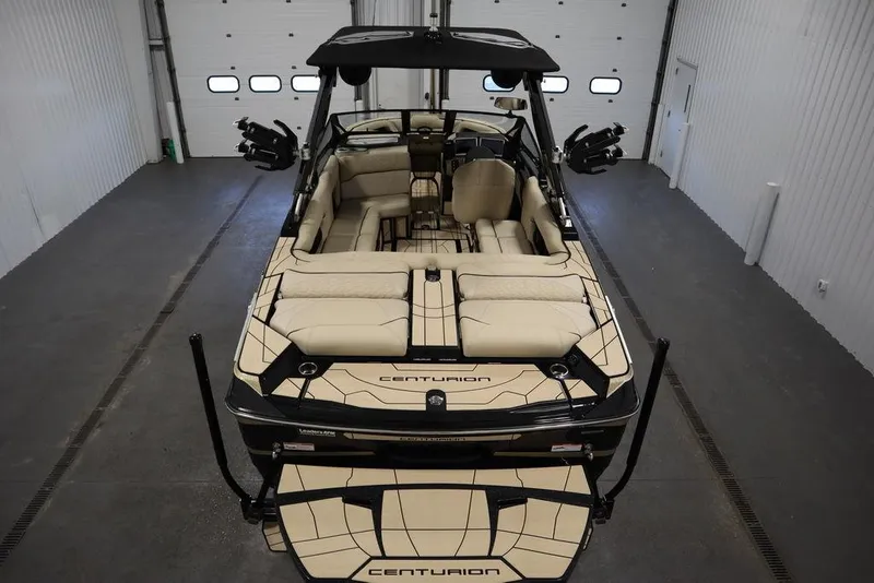 Slide: The Image of 2024 Centurion Ri230 boat in a garage, showcasing luxurious interior and sleek design. - 3