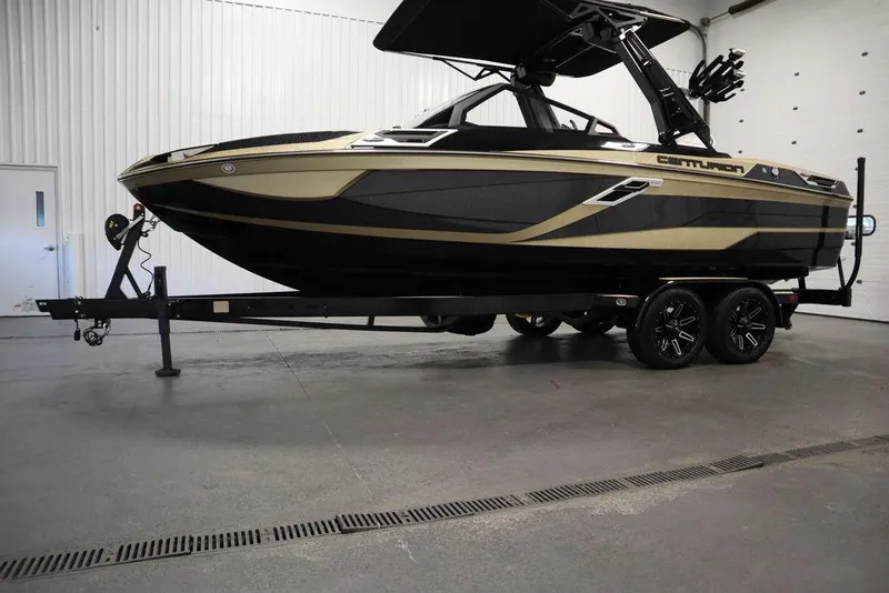 Slide: The Image of 2024 Centurion Ri230 boat on trailer in indoor showroom. - 30