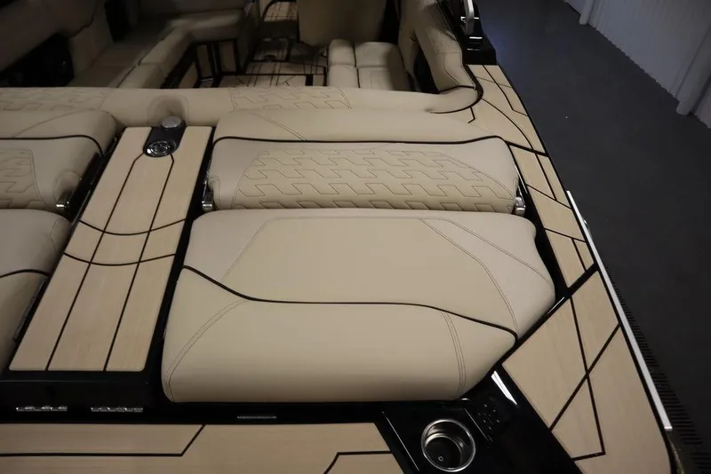 Slide: The Image of 2024 Centurion Ri230 boat interior with beige upholstery and sleek design. - 39