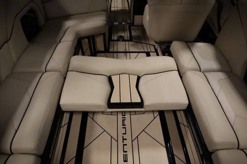 Slide: The Image of 2024 Centurion Ri230 boat interior with luxurious beige seating and sleek design. - 51