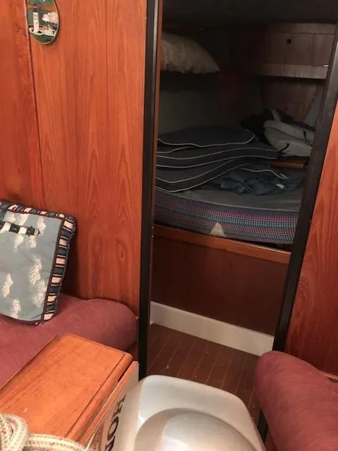 Slide: The Image of Interior cabin of a 1987 Hunter Legend 37 sailboat with wooden paneling. - 12