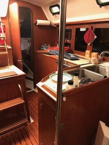 Slide: The Image of Interior of 1987 Hunter Legend 37 sailboat with wooden cabinetry and kitchen area. - 13