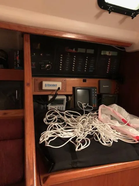 Slide: The Image of 1987 Hunter Legend 37 yacht interior with navigation equipment and coiled ropes. - 15