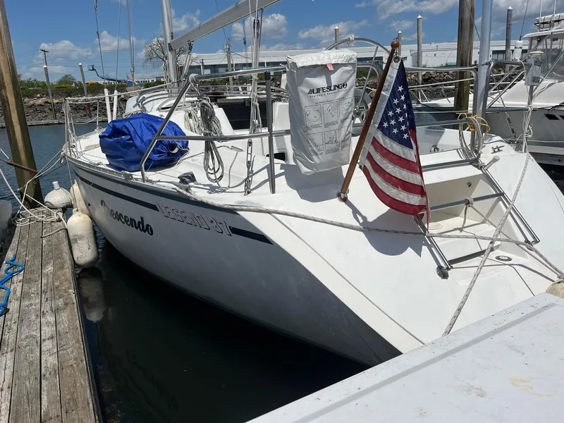 Slide: The Image of 1987 Hunter Legend 37 sailboat docked with American flag. - 2