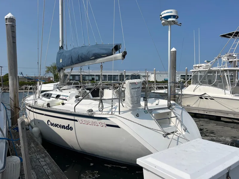Slide: The Image of 1987 Hunter Legend 37 sailboat named Crescendo docked at a marina. - 3