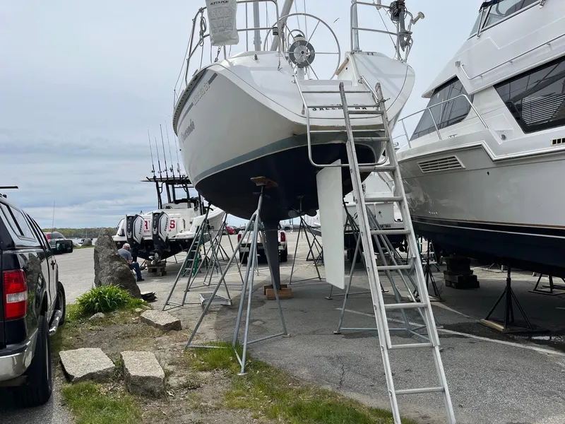 Slide: The Image of 1987 Hunter Legend 37 sailboat on stands for maintenance in a boatyard. - 5