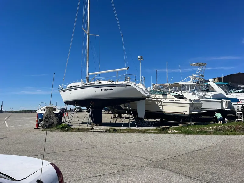 Slide: The Image of 1987 Hunter Legend 37 sailboat on dry dock under clear blue sky. - 8