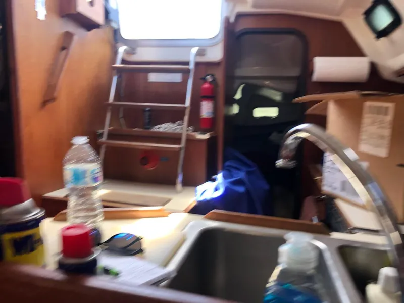 Slide: The Image of Interior of 1987 Hunter Legend 37 sailboat with kitchen sink and storage area. - 9