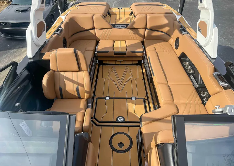 Slide: The Image of 2024 Supra SA boat interior with tan leather seating and modern design. - 12