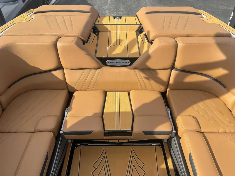 Slide: The Image of 2024 Supra SA boat interior with tan leather seating and stylish design. - 17