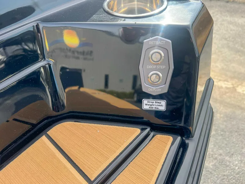 Slide: The Image of 2024 Supra SA boat drop step controls with weight limit label. - 24