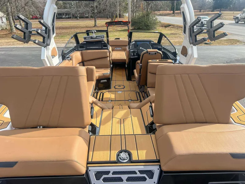 Slide: The Image of 2024 Supra SA boat interior with tan seating and sleek design. - 9